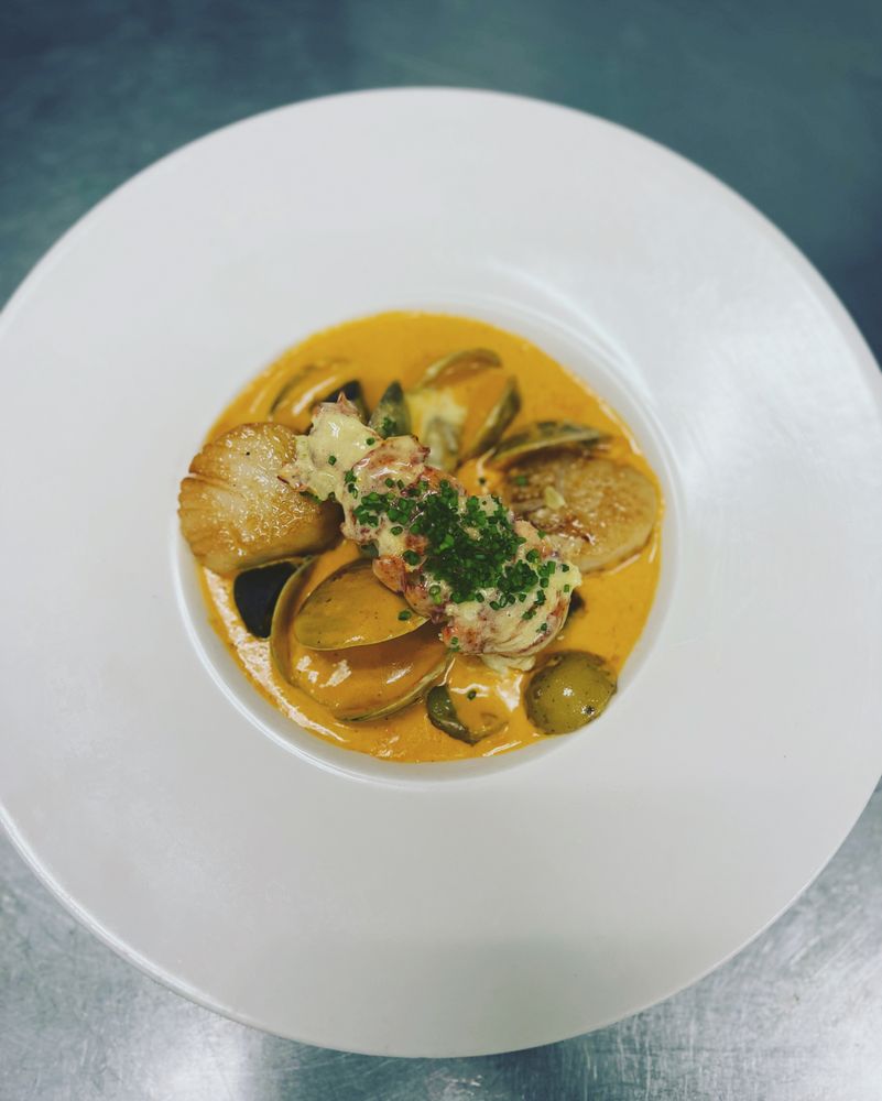 Seared scallops and lobster in saffron shellfish bisque