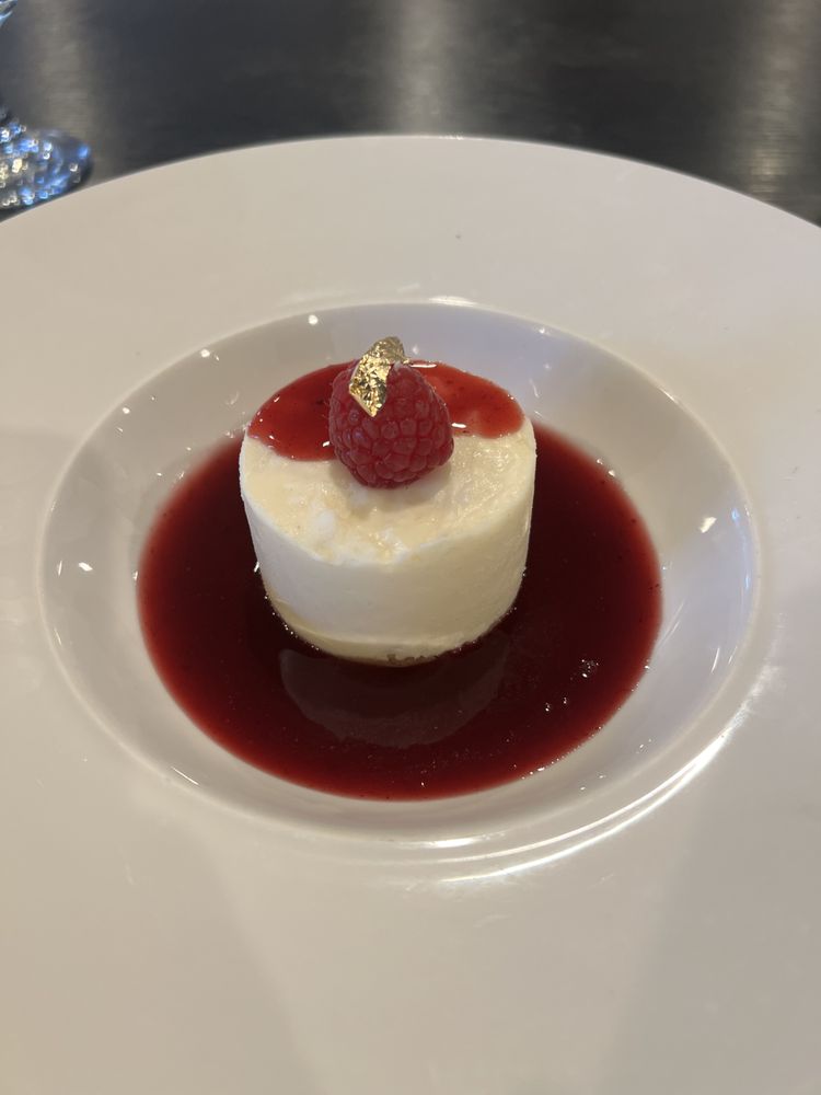 Gold leaf panna cotta with raspberry coulis